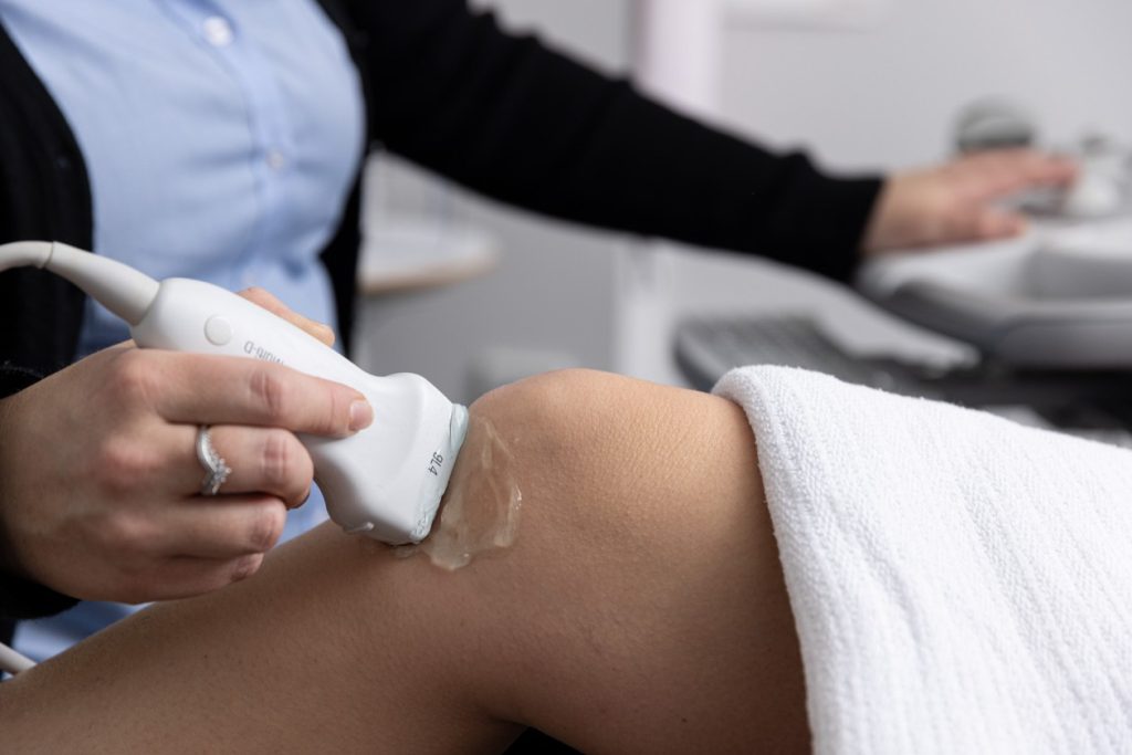 Sonographer doing a knee ultrasound at Imaging Queensland