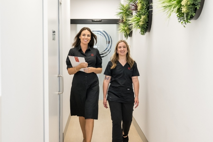 Administrator and Radiographer walking down passage at Imaging Queensland.